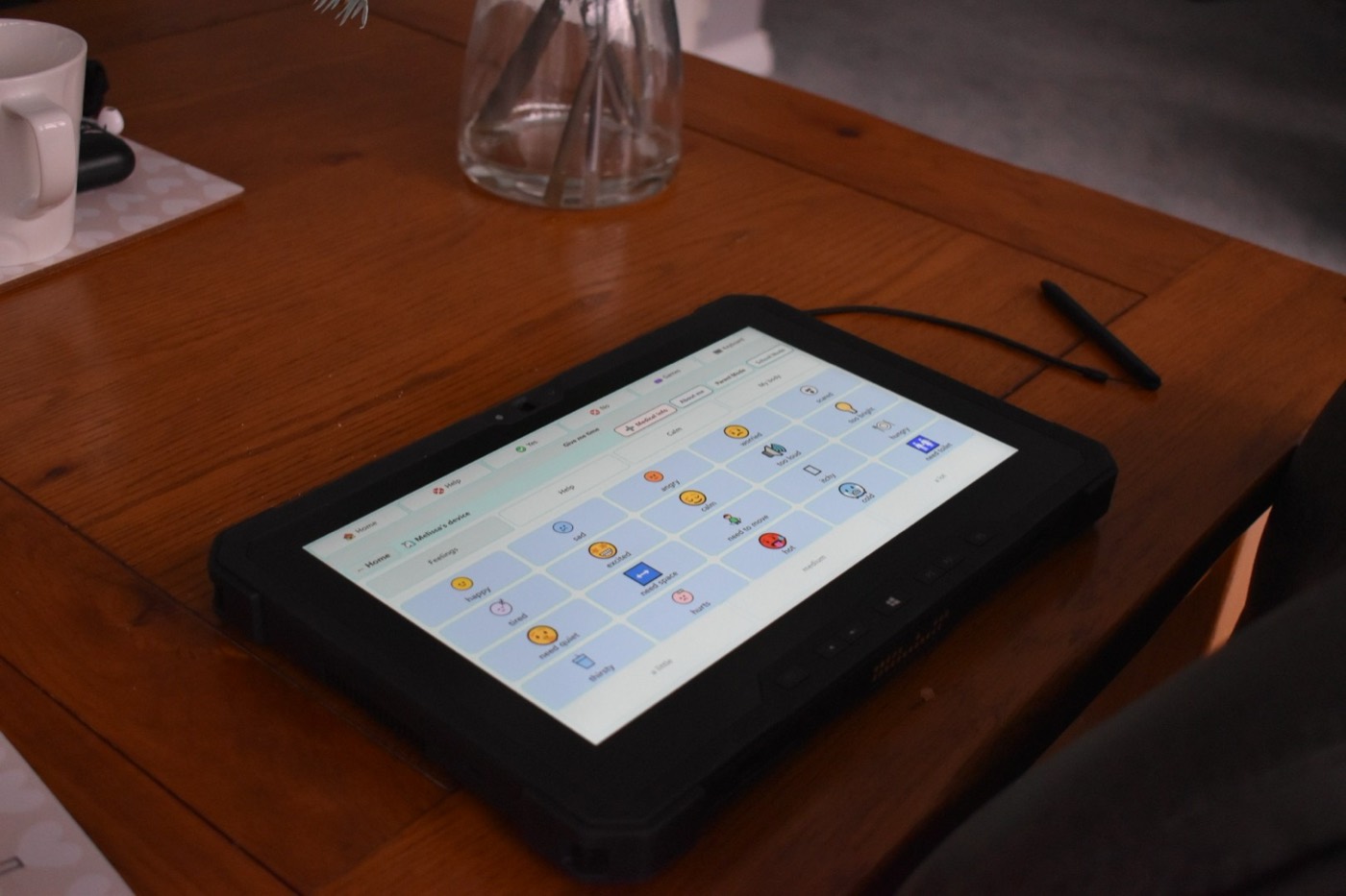 The Feelings page on a tablet on the kitchen table, with a mug and a stylus nearby